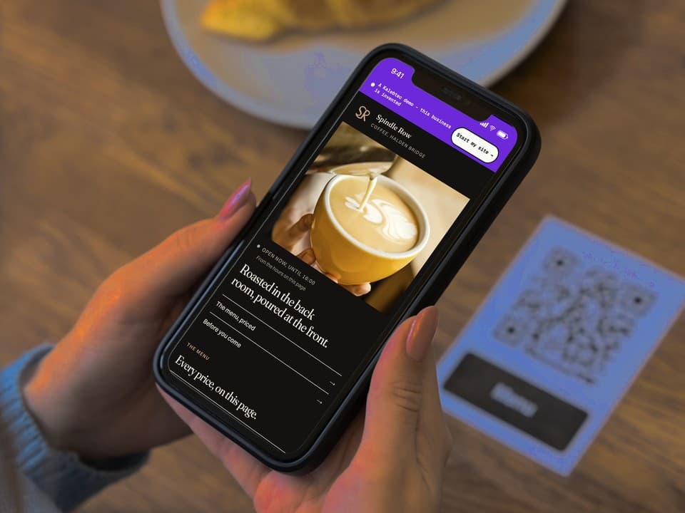 A phone open on the first screen of the Spindle Row Coffee demo: a photograph of the espresso counter, the headline "One long room, and no music before eight.", and a link to the priced menu.