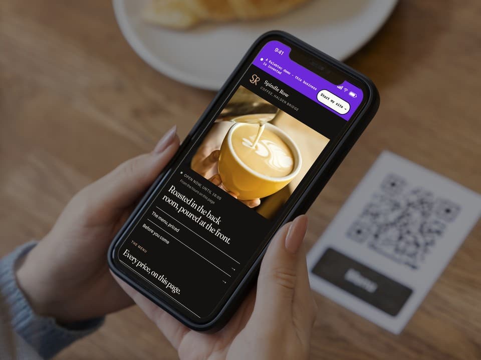 A phone open on the first screen of the Spindle Row Coffee demo: a photograph of the espresso counter, the headline "One long room, and no music before eight.", and a link to the priced menu.